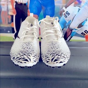 A pair of White and Black Nike Vapor cleats.